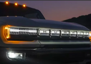 The grill of an illuminated Hummer EV parked outdoors near Carmel, Indiana