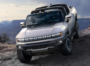 A white 2024 Hummer EV Pickup driving off-road near Carmel, IN