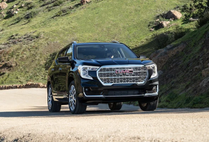 A 2024 GMC Terrain driving down a dirt road near Carmel, Indiana