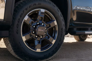 A close-up photo of the front driver's side tire of a 2025 GMC Sierra HD near Carmel, IN