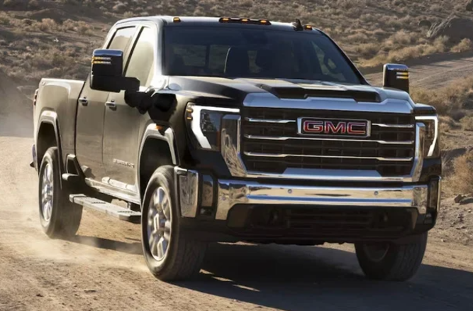 A 2024 GMC Sierra HD driving down a dirt road near Carmel, Indiana