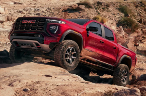 A 2024 GMC Canyon driving offroad in a rocky, desert-like area near Carmel, Indiana